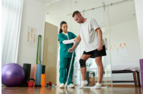 Nurse supporting patient learning to walk